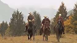 DS Three ranchers riding across meadow Stock Footage