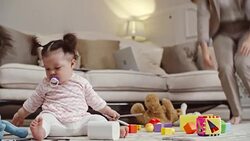 Entrepreneur mom working and playing with baby at home Stock Footage