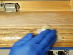 Gloved Hand Staining Oak Window Trim Stock Footage