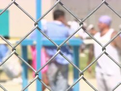 CU Prisoners talking behind fence area at California state prison in Los Angeles country / Lancaster, California, USA Stock Footage