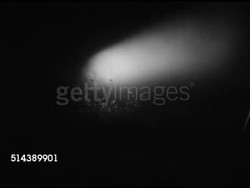 1953: PATROLLING MALAYA JUNGLE: NIGHT: VS Spotlight sweeping slowly over vegetation, silhouette of barbed wire fence.      Commonwealth, protection, Communist guerrillas. Instructional Video