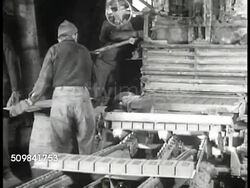 1946: BUILDING SUPPLIES: BRICKS: EXT Jova Brickyard in Newburgh, New York w/ men moving Hudson Valley red clay in open barrels on track, bricks being sorted, crane moving large stack of bricks inside warehouse. Instructional Video