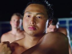 CU Waterpolo team standing poolside and stretching arm / Riverside, California, United States Stock Footage