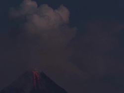 T/L video of ash exploding from volcano at dawn and lava spilling from crater, Philippines, Dec 2009 Stock Footage