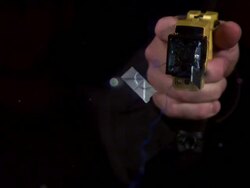 Medium Close Up, Locked Down - Electrodes snake out of a taser / USA Stock Footage