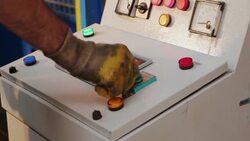 Worker operating a machine in a factory Stock Footage