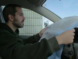 MS Man sitting in car and looking at road map / Campton, Kentucky, United States Stock Footage