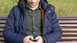 Young male texting on cell phone Stock Footage