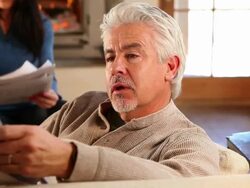MS PAN Husband and wife reading newspaper on couch / Lamy, New Mexico, United States Stock Footage