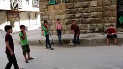 Children playing in street in Aleppo - Relentless barrel bombing of the city of Aleppo continues. News Clip