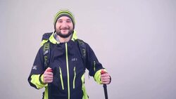 tourist with a backpack and walking sticks Stock Footage