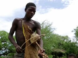 hadzabe-boy playing a stringed instrument Stock Footage