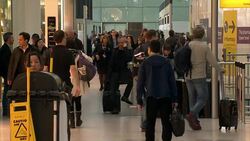 Crowd of Passengers at Heathrow Airport News Clip