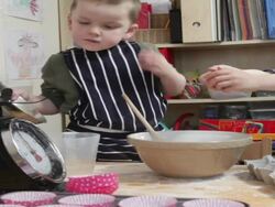 Two young boys making cakes together on kitchen table full of excitement  Stock Footage