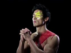 Man with Chinese flag painted on face and chest, hands clasped Stock Footage