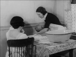 B/W 1934 nurse taking baby from bath as other woman  with baby watches / WPA project / newsreel Stock Footage