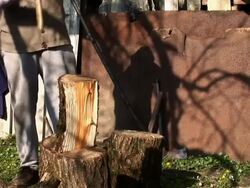 HD: Old man cleaving wood Stock Footage