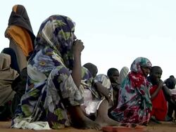 Refugees sitting and waiting at refugeee camp Stock Footage