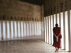 WS Shot of Monk dressed in traditional cloths in Walkway to Shwezigon Pagoda / Bagan, Burma  Stock Footage