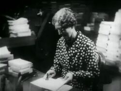 B/W 1934 senior woman stamping books in library in WPA project / documentary Stock Footage