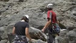 A couple celebrating and slapping hands giving a ï¿½ï¿½high fiveï¿½ï¿½ while rock climbing. Stock Footage