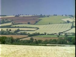T/L landscape, fields on hill, locked shot, Over Norton Stock Footage