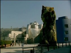 WA Jeff Koons flower statue foreground, Guggenheim museum, Bilbao, Spain Stock Footage