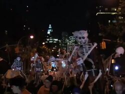 Large skeletons come down the parade route of the NYC Halloween parade Stock Footage