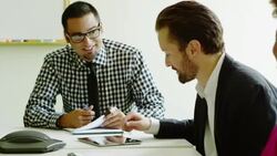 MS Smiling businessman discussing project on digital tablet with coworkers in office conference room Stock Footage