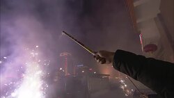 A man shoots fireworks into the sky at a Chinese New Year celebration. Stock Footage