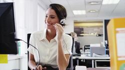 Businesswoman wearing headset using computer Stock Footage