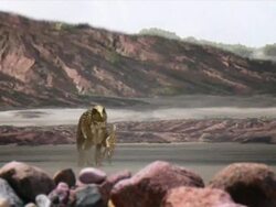 Long Shot pan-right push-in - A four-legged creature chases a two-legged creature near mountains in a computer-generated animation. / New York City, New York, USA Stock Footage