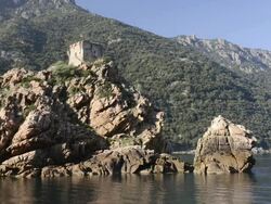 WS Shot of Genovese tower at rocky coast, UNESCO world heritage / Gulf of Porto, Corsica, France Stock Footage