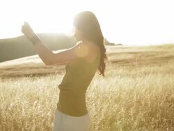 Caucasian woman taking photographs in rural field Stock Footage