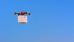 SLO MO UAV transporting a cardboard box package Stock Footage