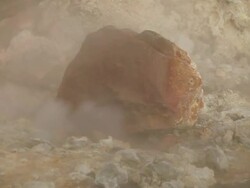 CU Rock sitting surrounded by rising steam in Krysuvik Geothermal area / Reykjanes peninsula, Iceland       Stock Footage