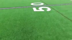 Counting Down Yard Lines close to Green Astro Turf Football Field perfect close angle Stock Footage