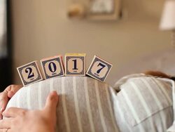 A pregnant women using blocks to spell the word 2017 on her stomach. Stock Footage