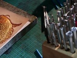 leatherworker paint  fish pattern on leather Stock Footage