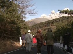 People watch steam and ash pour from Kirishima volcano Shinmoe crater / AUDIO Stock Footage