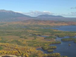 WS AERIAL PAN ZI TD View of wooded area with autumn color and lakes / Maine, United States Stock Footage
