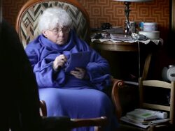 Old woman playing video game Stock Footage