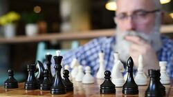elderly man puts mate in chess Stock Footage