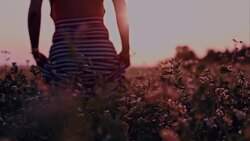 SLO MO Woman walking in field of buckwheat Stock Footage
