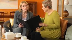 Professional Explains Documents to Senior Woman Stock Footage