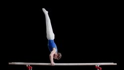 SLO MO Gymnast doing hand stand on parallel bars Stock Footage