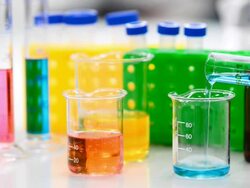 Pouring blue liquid into Beaker Stock Footage