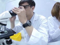 HD : Scientist Couple using microscope Stock Footage