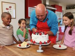 MS Chef serving cake to children (6-11) / Los Angeles, California, USA Stock Footage