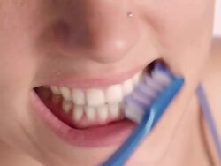 Cheerful young woman brushing teeth. Stock Footage